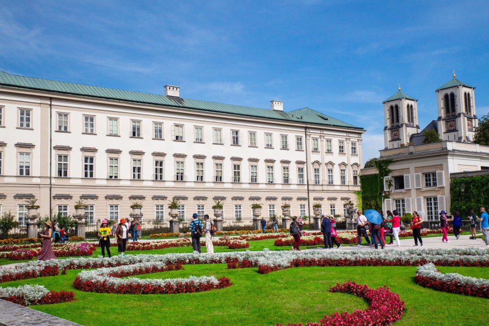 a group of people standing in front of a large building