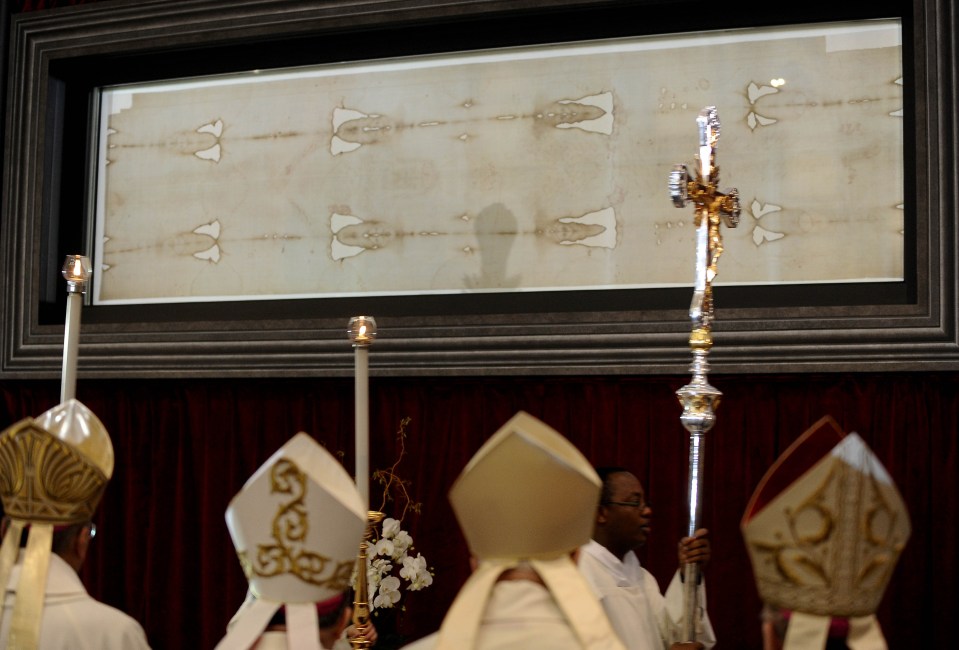 Bishops seen standing in front of the Shroud of Turin at the end of a mass