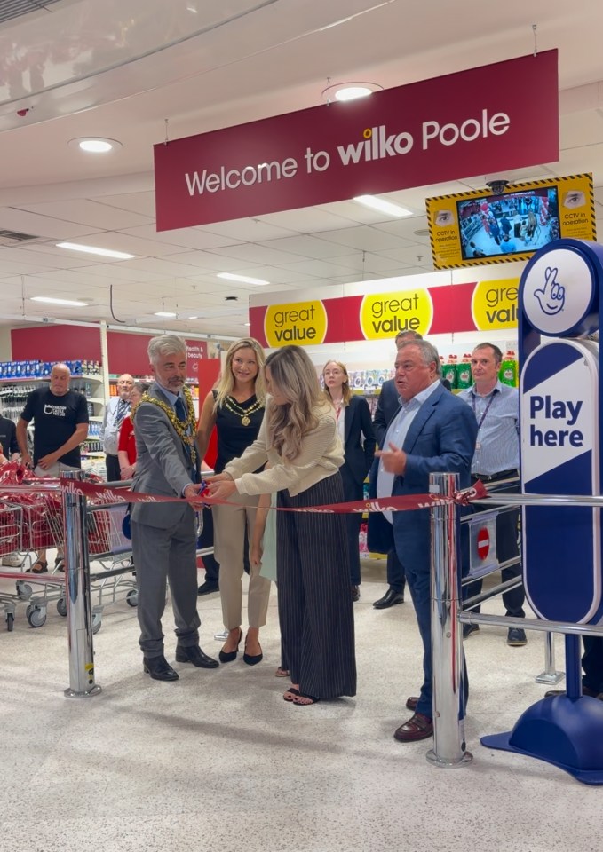 A woman cuts a ribbon signalling the opening of Wilko Poole