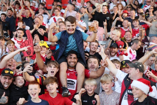 a crowd of people with one wearing a shirt that says selco