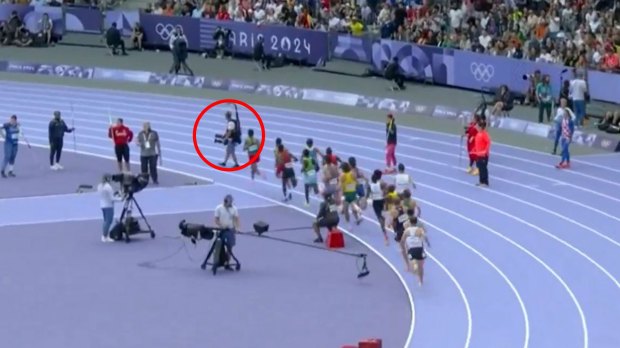 a group of people running on a track with a sign that says 2024