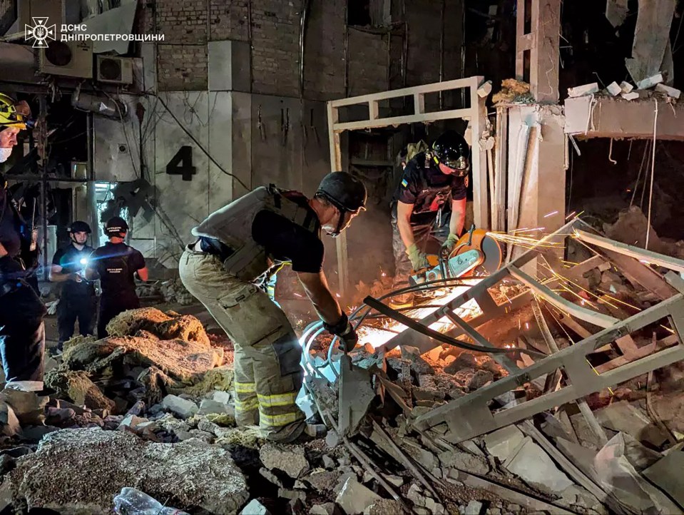 This handout photograph taken and released by the Ukrainian Emergency Service on August 27, 2024 shows rescuers in action on a site of a heavily damaged hotel following an air attack in Kryvyi Rig. Ukraine said on August 27, 2024, that its air defence systems had downed five missiles and 60 attack drones in a second night of Russian aerial bombardments that killed four. The overnight attacks came one day after the Kremlin launched one of its largest-ever aerial attacks on Ukraine that battered energy facilities and left several dead. (Photo by Handout / UKRAINIAN EMERGENCY SERVICE / AFP) / RESTRICTED TO EDITORIAL USE - MANDATORY CREDIT "AFP PHOTO / HANDOUT / UKRAINIAN EMERGENCY SERVICE" - NO MARKETING NO ADVERTISING CAMPAIGNS - DISTRIBUTED AS A SERVICE TO CLIENTS (Photo by HANDOUT/UKRAINIAN EMERGENCY SERVICE/AFP via Getty Images)