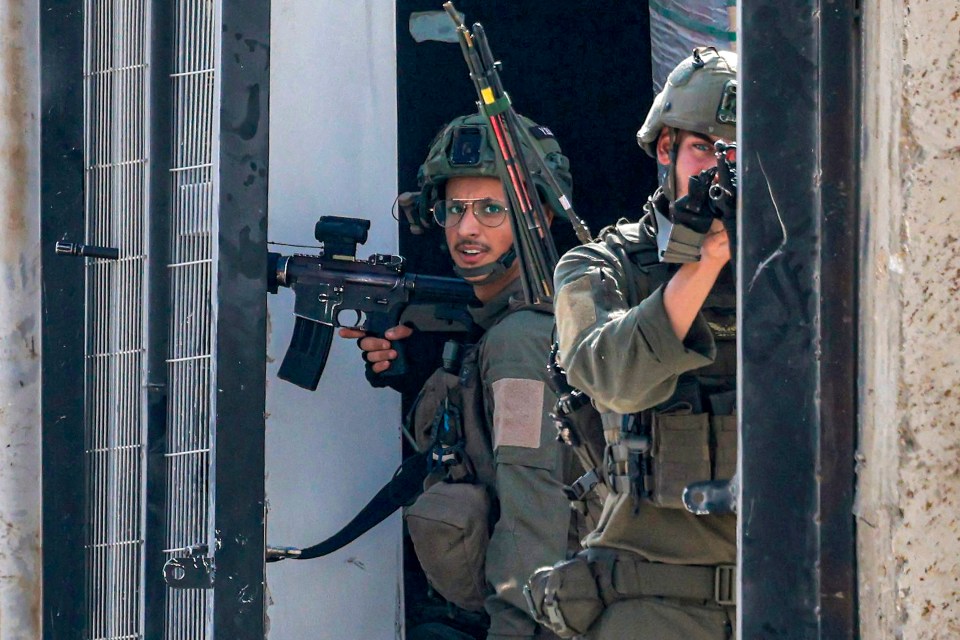 An Israeli soldier aims during a shootout in Tulkarm