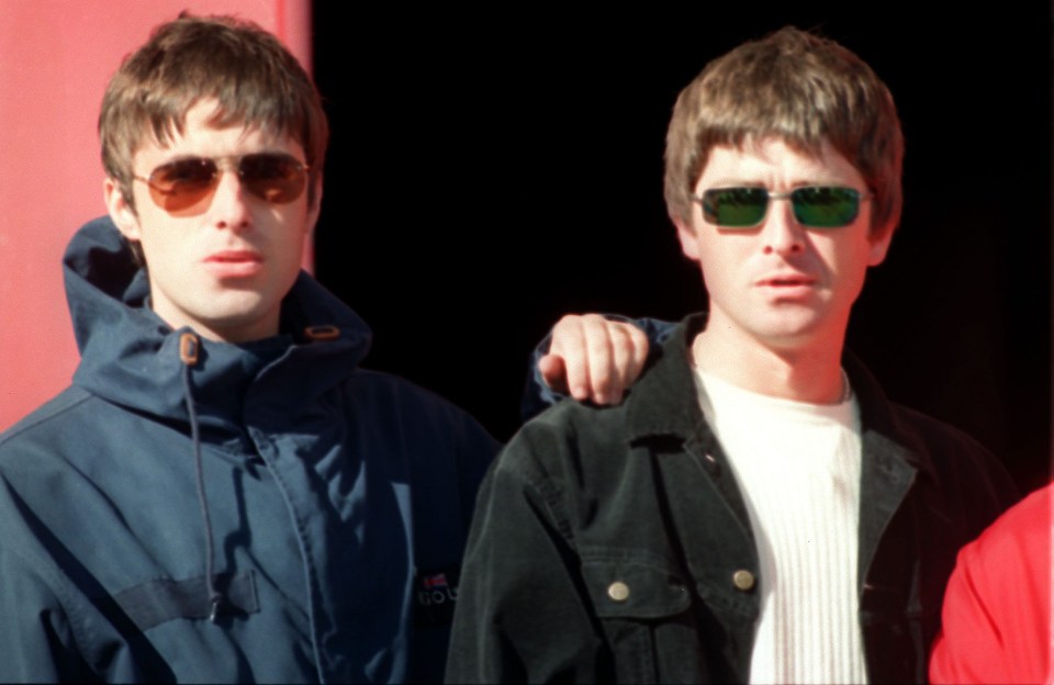 two men standing next to each other one wearing a jacket that says adidas