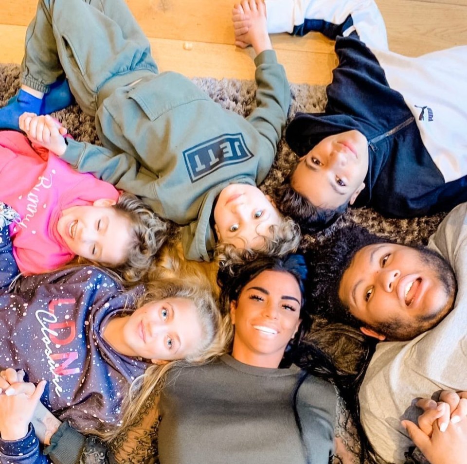 a group of people laying on the floor with one wearing a sweatshirt that says lett