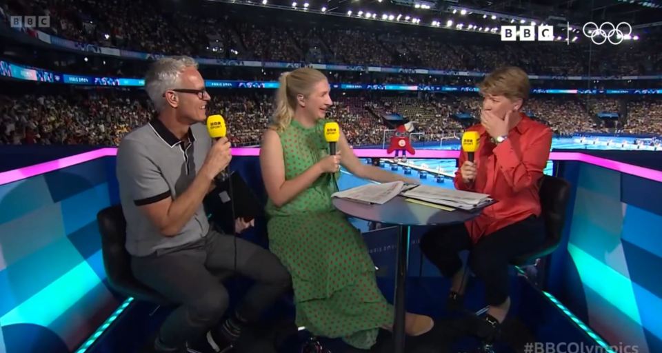 three people sitting at a table with microphones in front of a bbc logo