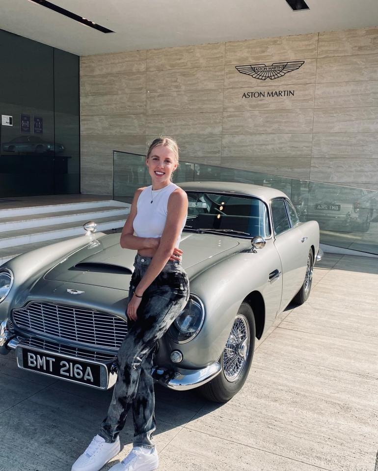 Keely Hodgkinson, Olympic 800m runner, posing with an Aston Martin DB5.