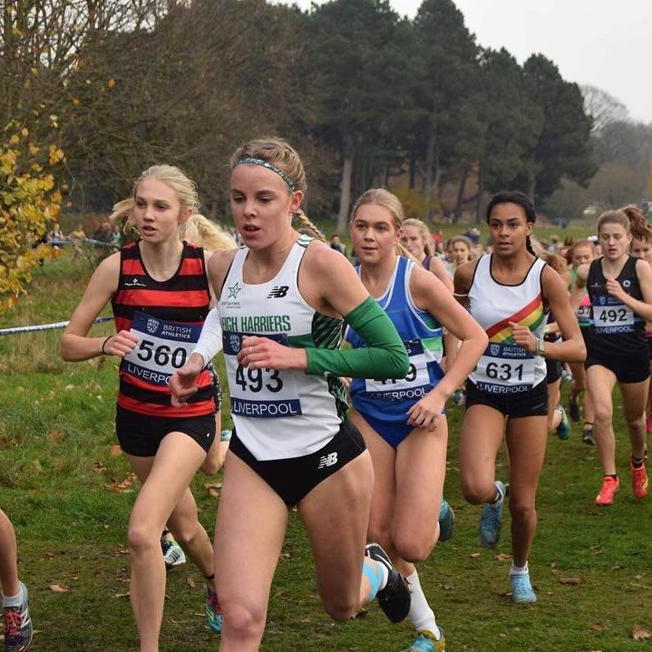 Female runners competing in a cross-country race.