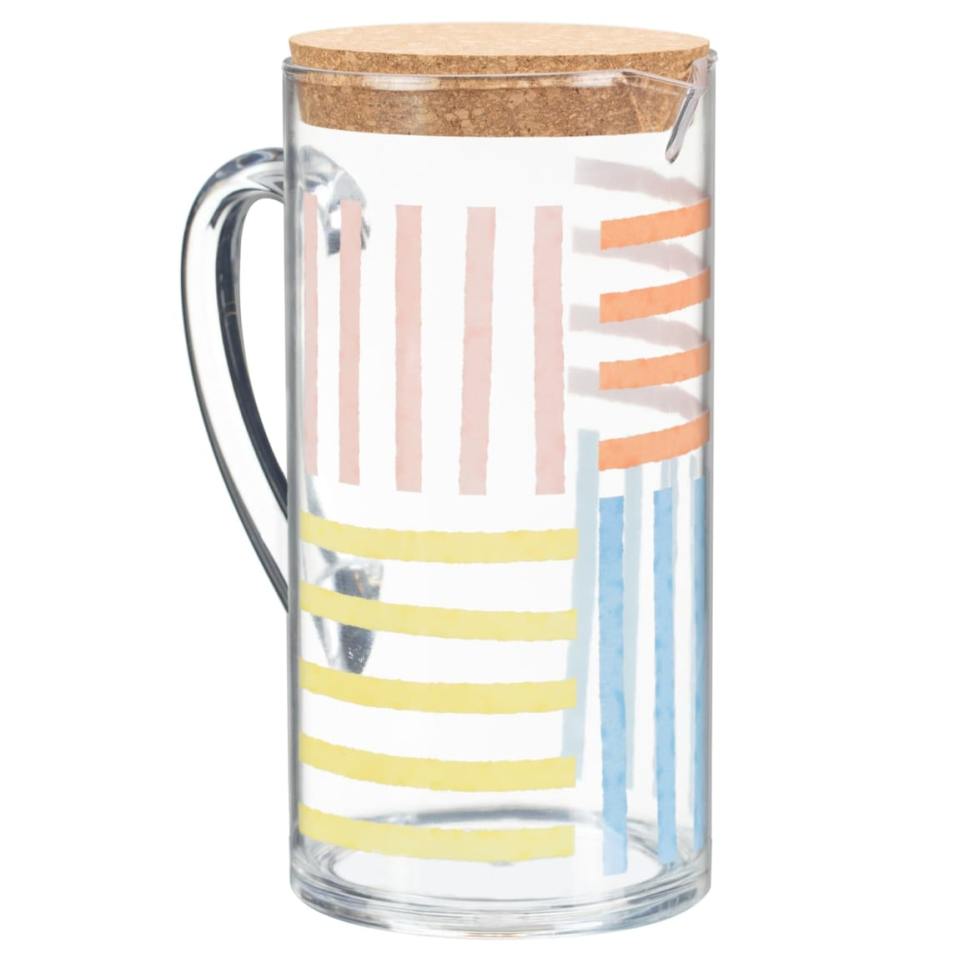 a clear glass pitcher with a cork lid