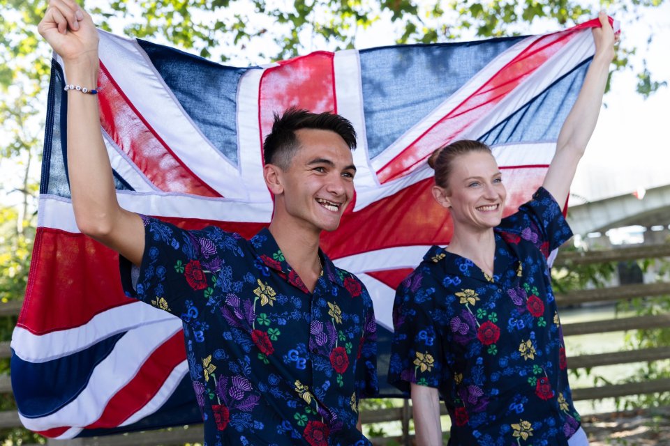 a man and a woman holding a british flag