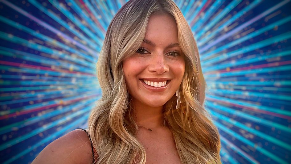 a woman with long blonde hair is smiling in front of a blue background