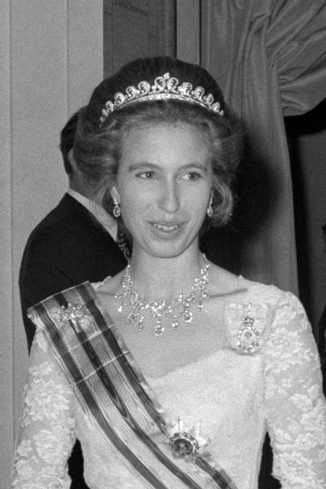 a black and white photo of a woman wearing a tiara