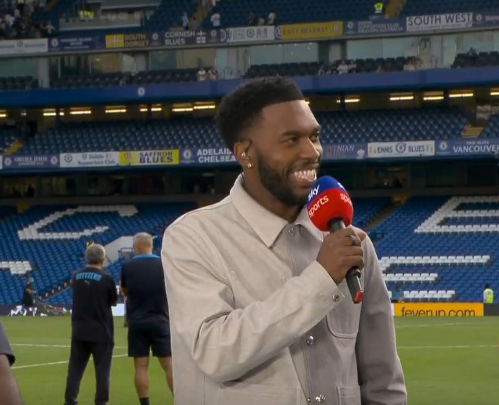 a man holding a microphone with a sky sports logo on it