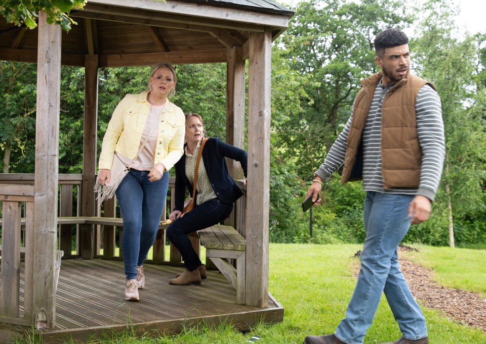 a group of people are walking around a gazebo