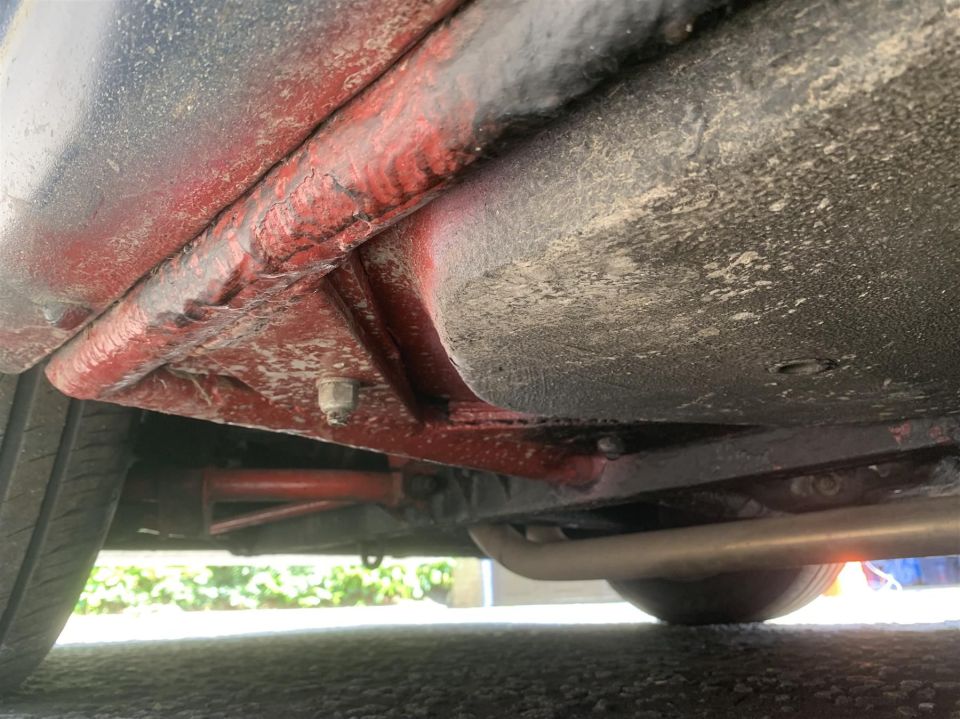 a close up of the underside of a red car