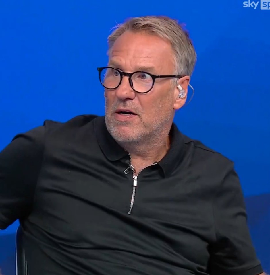 a man wearing glasses and a black shirt is sitting in front of a blue sky