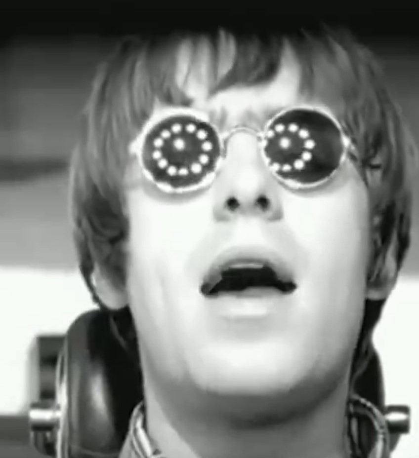 a black and white photo of a man wearing sunglasses and headphones .