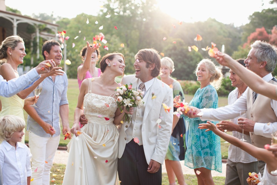 a bride and groom are celebrated by their wedding party