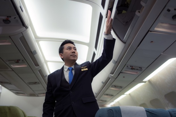 a man in a suit with a name tag that says ' captain ' on it