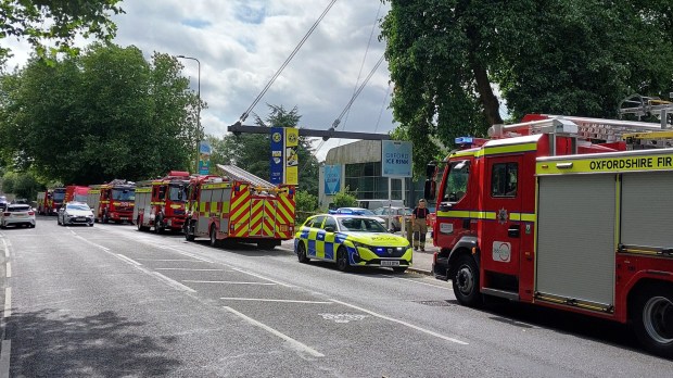 an oxfordshire fire truck is parked on the side of the road