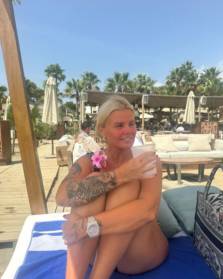 The former singer showed off her tattooed physique on holiday