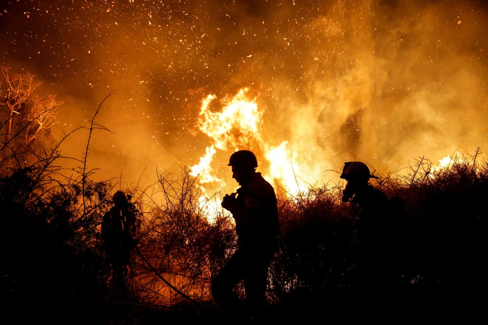 Firefighters work to put out a fire in an open field, following a mass-infiltration by Hamas gunmen from the Gaza Strip, near a hospital in Ashkelon, southern Israel October 7, 2023. REUTERS/Amir Cohen TPX IMAGES OF THE DAY