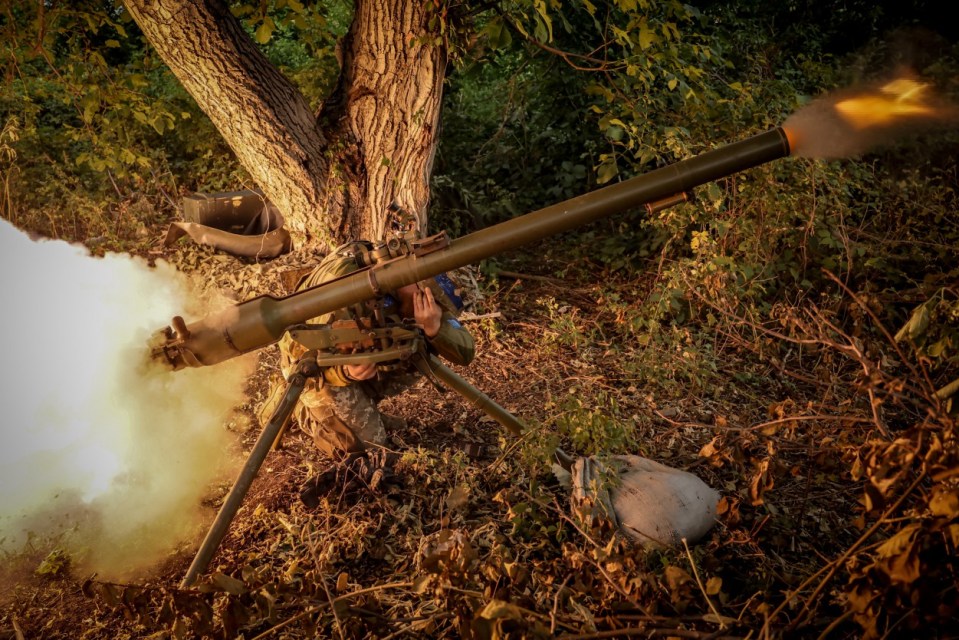 Ukrainian Armed Forces fire a grenade launcher towards Russian troops as the war for Ukraine rages on