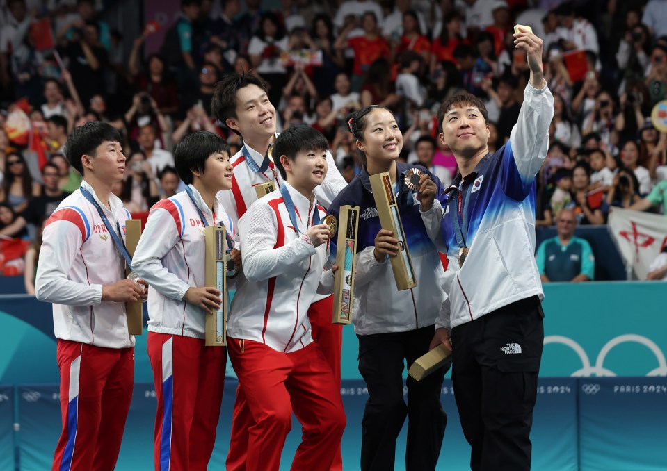 In a very rare show of solidarity, North Koreans posed for a selfie - with South Koreans