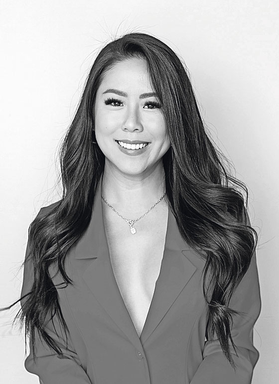 a black and white photo of a woman wearing a necklace