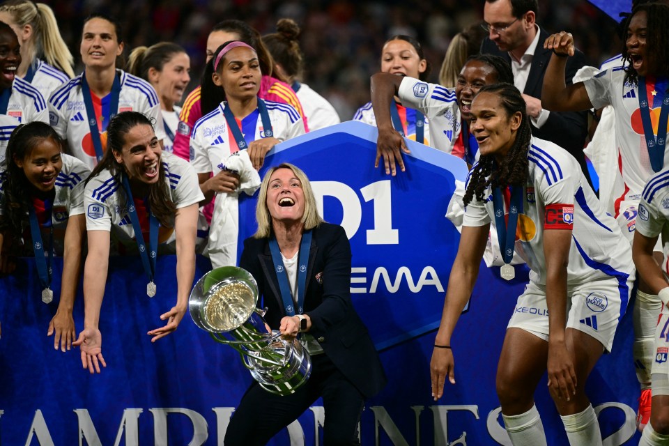 Lyon's French coach Sonia Bompastor prepares to lift the trophy as she celebrates with her players after they were crowned French Women's D1 Champions at the end of the D1 Women's football match between Lyon (OL) and Paris (PSG) at the Groupama Stadium in Decines-Charpieu, central-eastern France, on May 17, 2024. (Photo by OLIVIER CHASSIGNOLE / AFP) (Photo by OLIVIER CHASSIGNOLE/AFP via Getty Images)