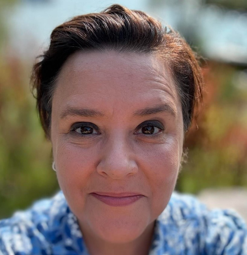 a close up of a woman 's face with a smile on her face