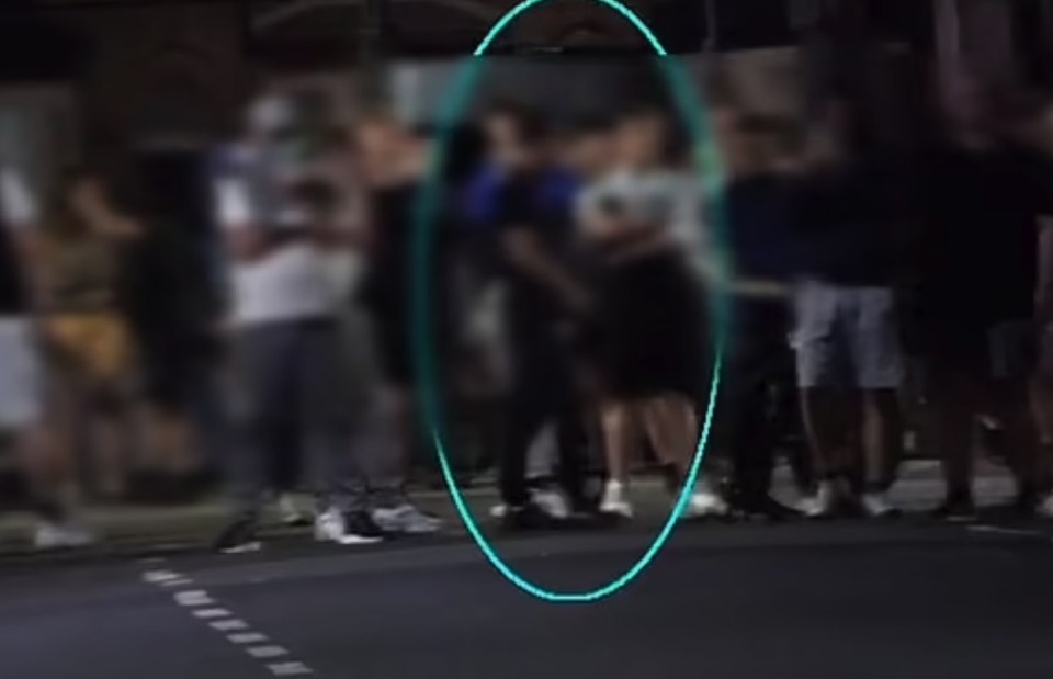 a blurry picture of a group of people standing on a street