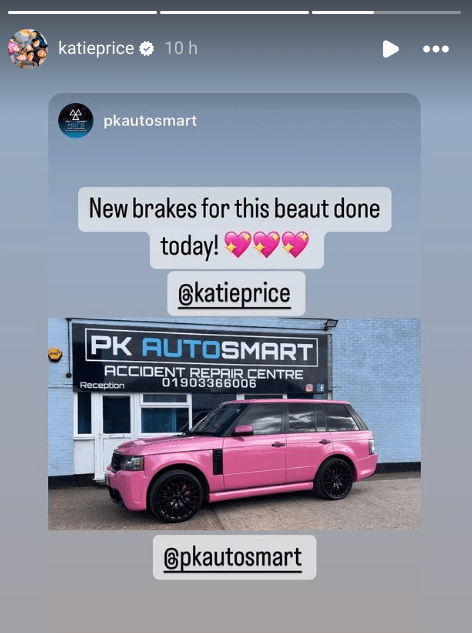 a pink car is parked in front of a sign that says pk autosmart