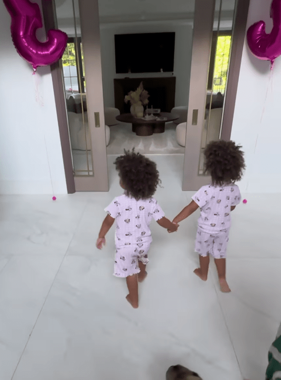 The tots held hands as they walked into the living room, which was full of presents