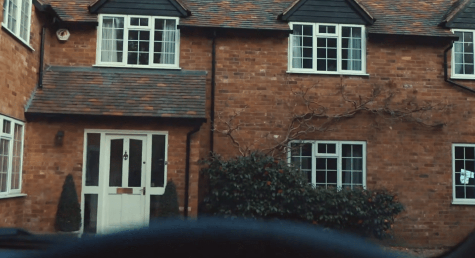 a brick house with a white door and windows