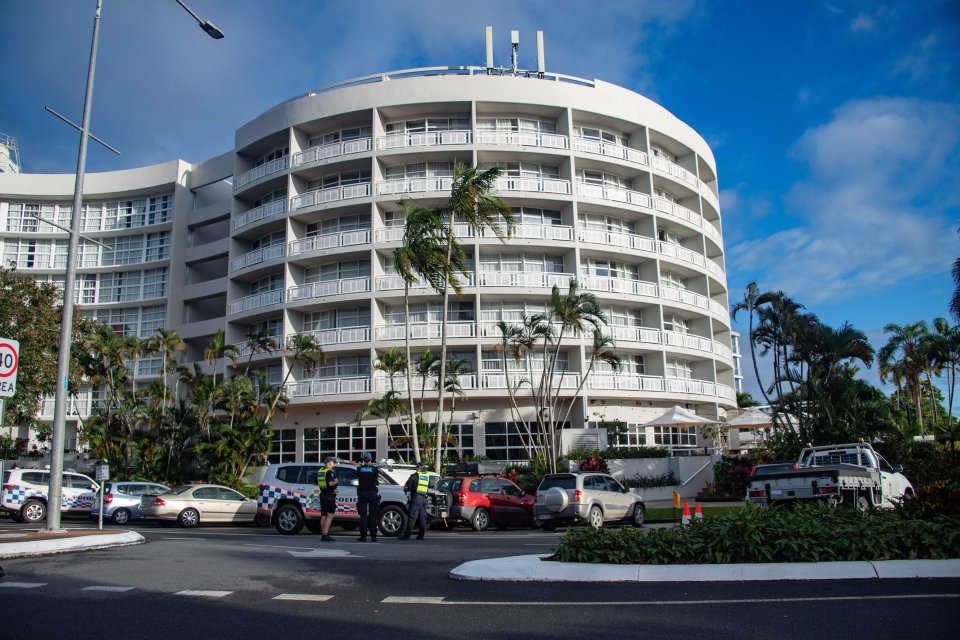 two police officers stand in front of a large white building