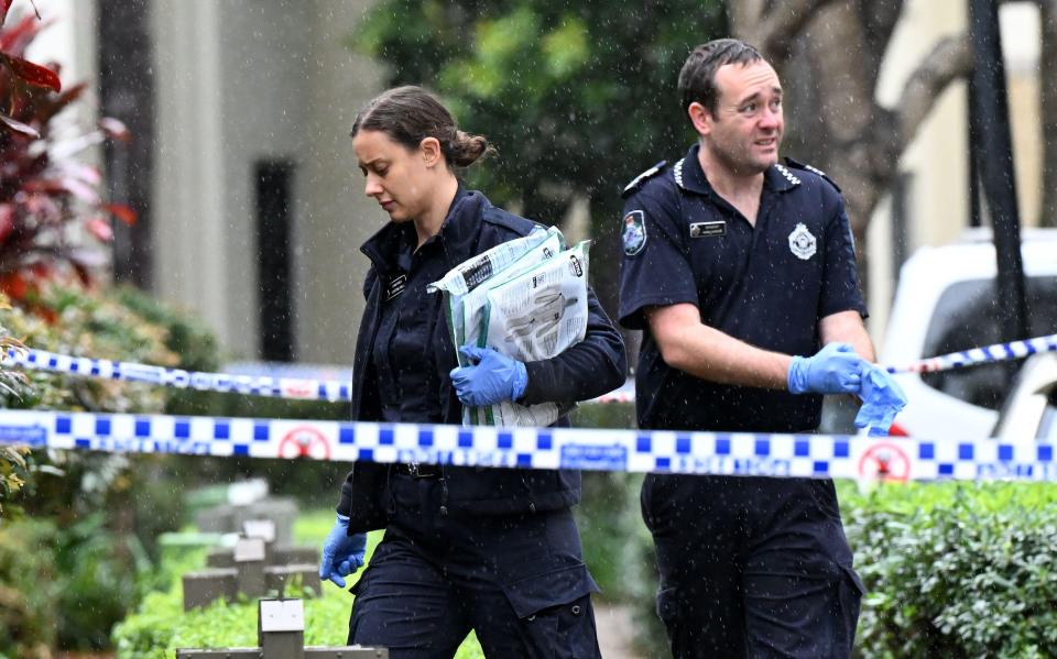 two police officers are walking through a checkered blue and white tape