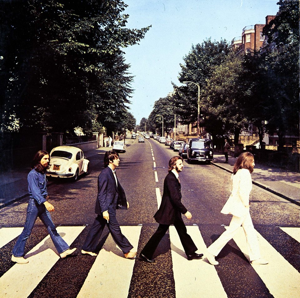 a photo of the beatles crossing a street