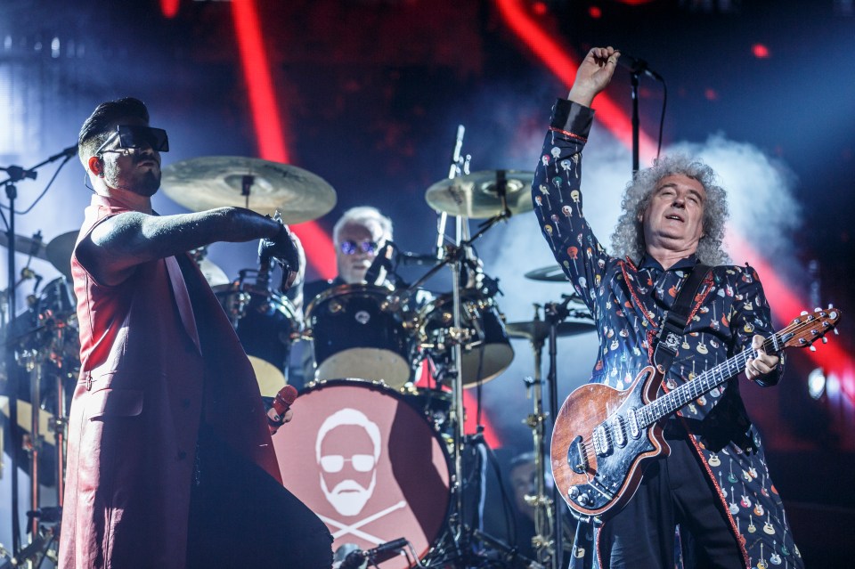 a man playing drums and a man playing a guitar on a stage