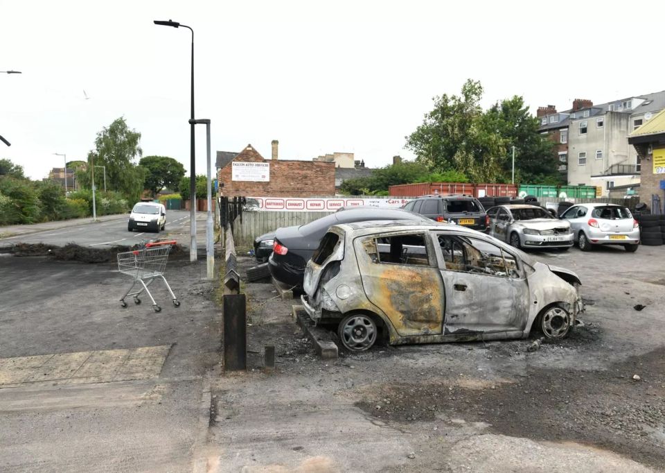 Aftermath of rioting in Hull city centre showing looted and damaged shops and vehicles