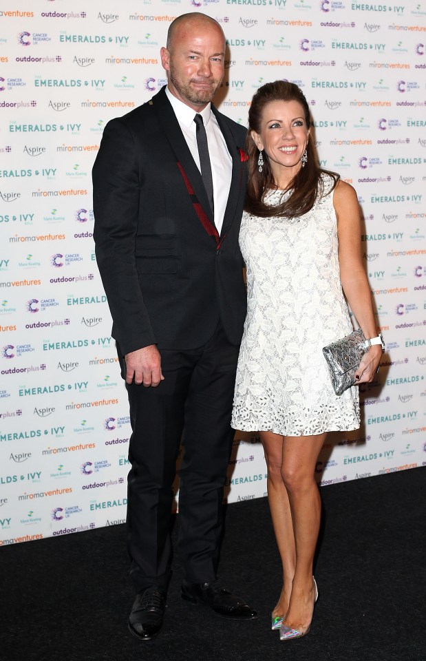 a man and woman pose in front of a wall that says emeralds + ivy