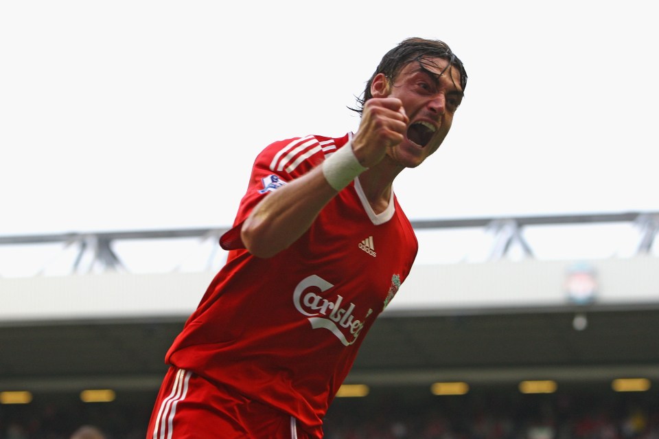 a soccer player wearing a red carlsberg jersey