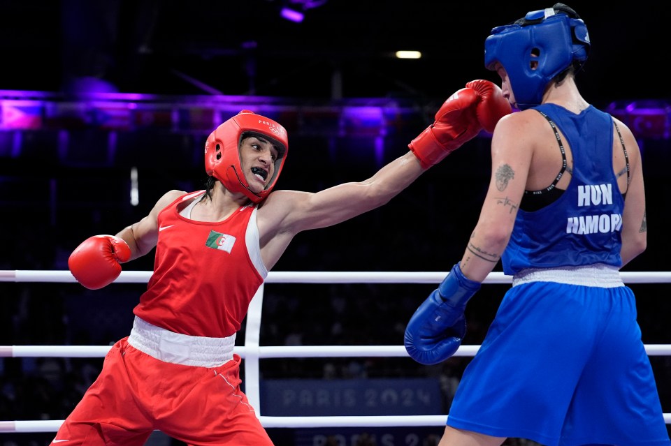 two boxers in a ring with one wearing a shirt that says hun