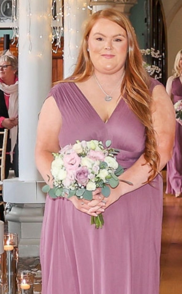 a woman in a purple dress is holding a bouquet of flowers