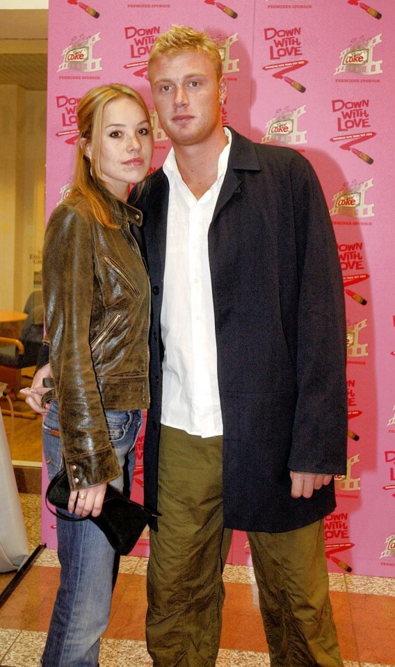 a man and woman pose in front of a pink wall that says down with love