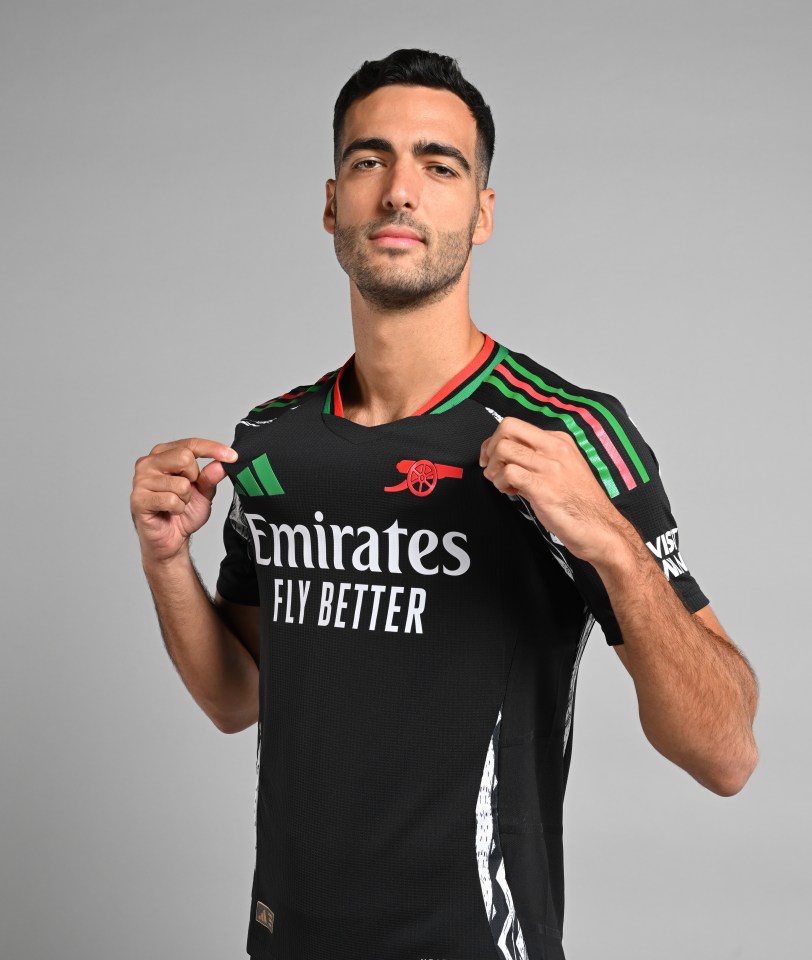 a man wearing a black emirates fly better shirt