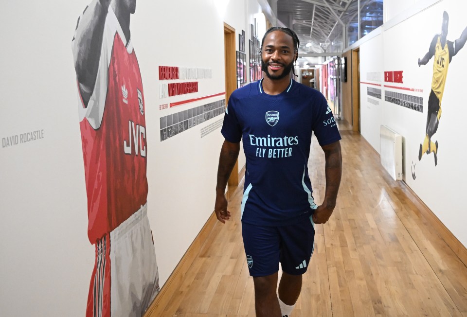 a man wearing a blue shirt that says emirates fly better