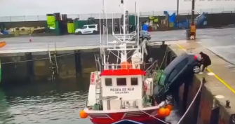 The driver desperately tried to stop the car from falling in as it rolled to the edge