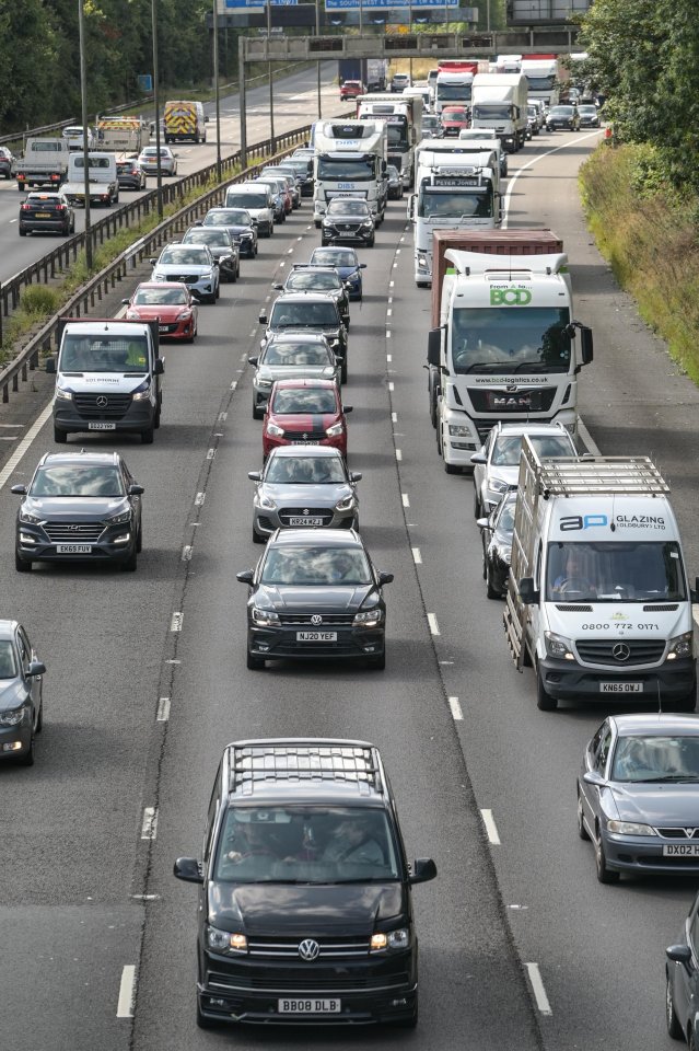 a busy highway with a van that says 3d glazing on the roof