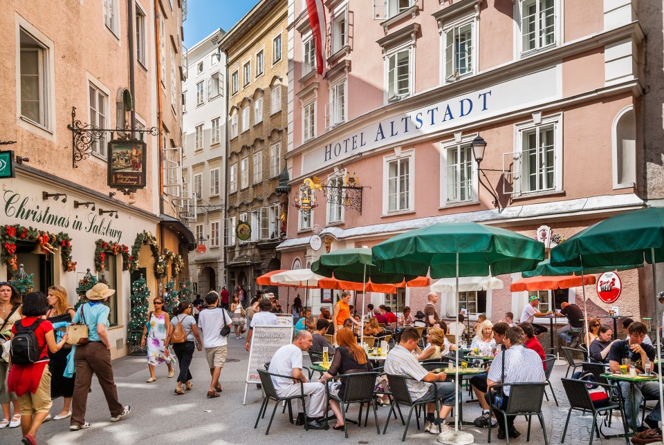 a christmas in salzburg sign hangs above a restaurant